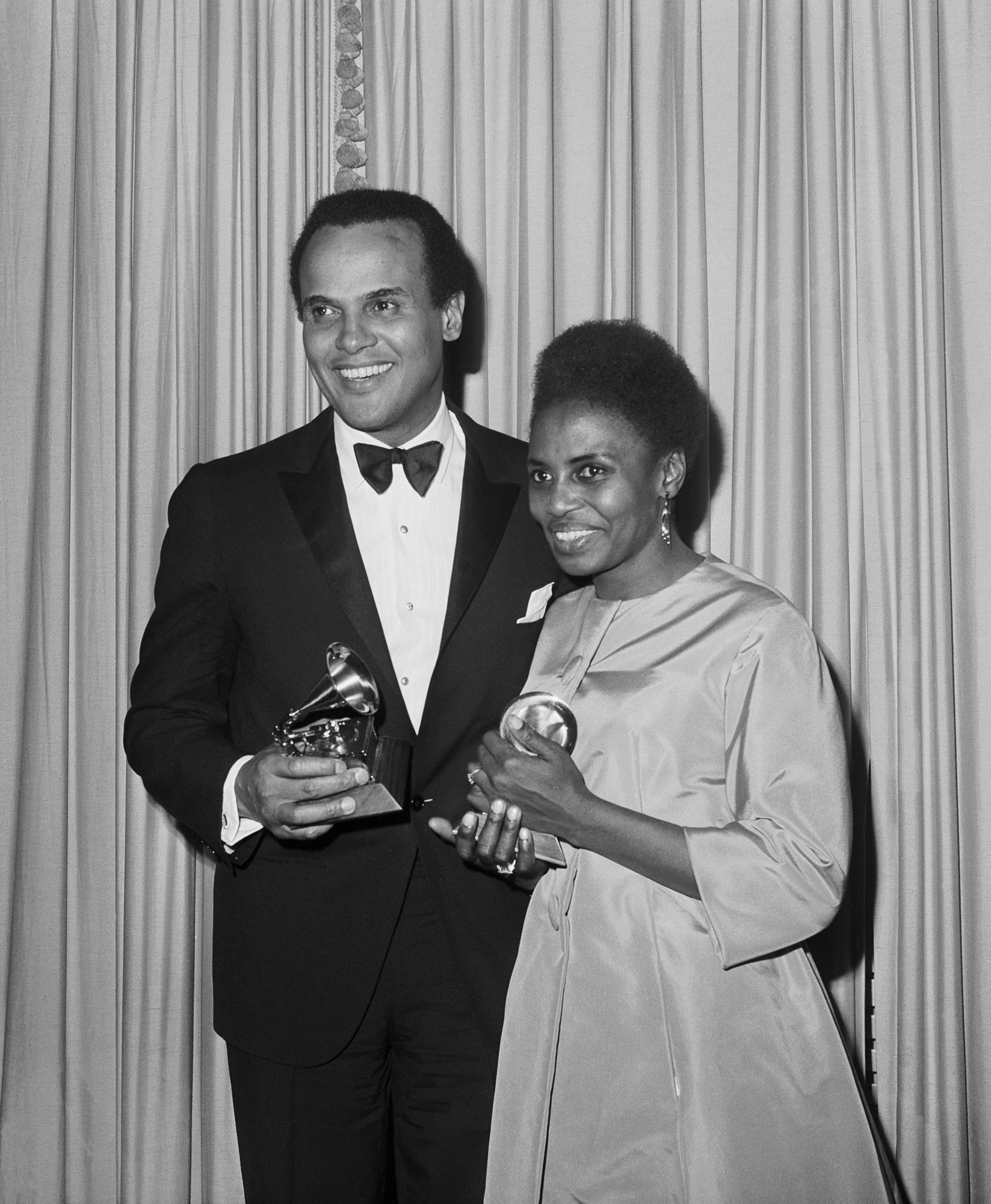 Harry Belafonte and Miriam Makeba holding their Grammy Awards for Best Folk Recording, 1965. Photo via Bettmann/Getty Images.